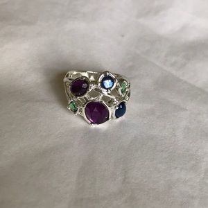 Silver-tone ring with purple, blue, green beads.